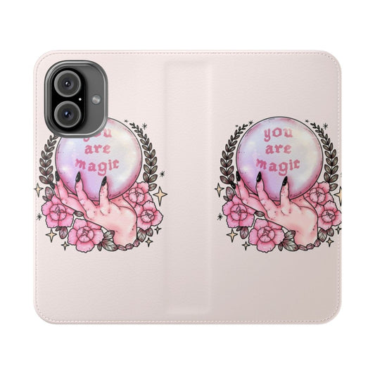 A pink phone case with a floral and crystal design