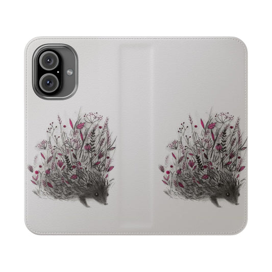 A close-up photo of a cute hedgehog on a phone case with a floral and botanical pattern.