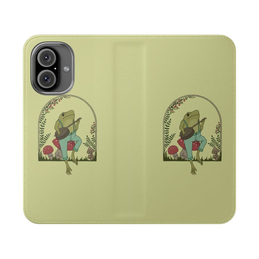 Vintage-style flip cover phone case featuring a cute frog playing a banjo on a mushroom in a cottagecore aesthetic garden.