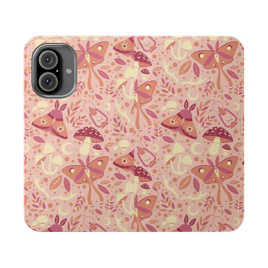 Closeup of a pink phone case with a detailed pattern of moths, mushrooms, and other forest elements.