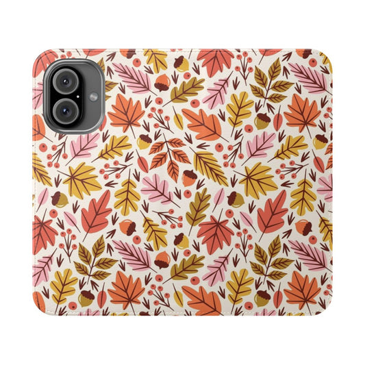 A phone case featuring a design of colorful autumn leaves and acorns against a pink and orange background.